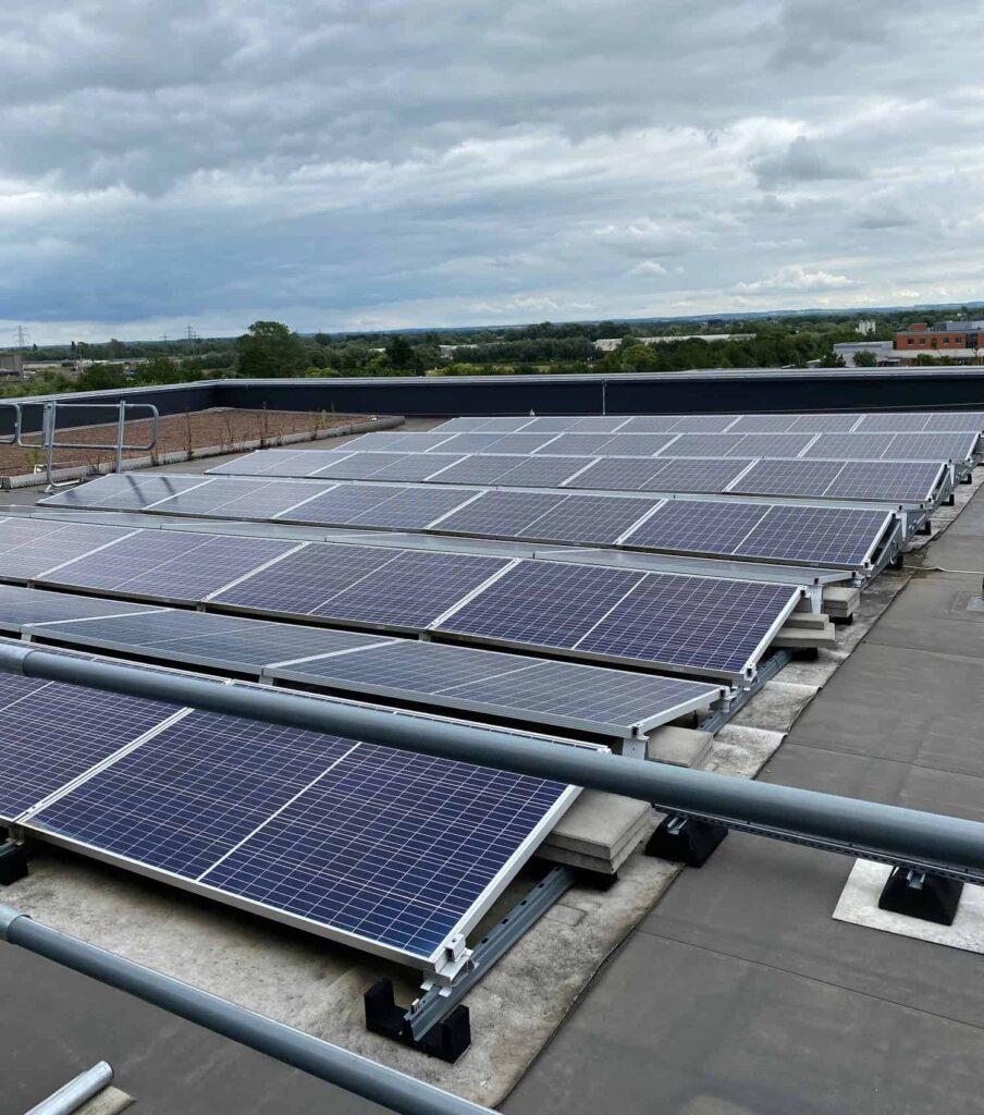 Commercial solar panel cleaning Oxfordshire A large group of solar panels on the roof of a business premises in Oxfordshire