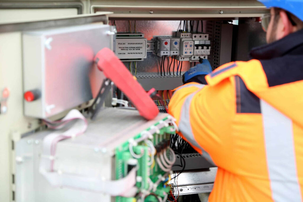 An EV Solar technician making repairs on an inverter control box in Buckingham, England