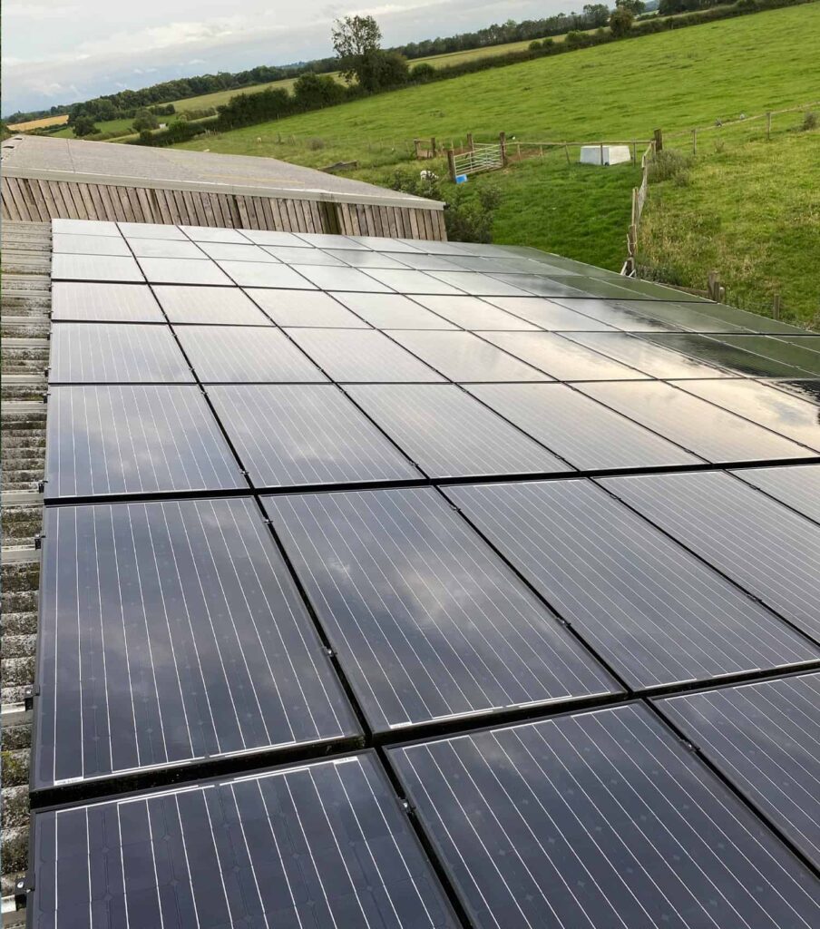 Commercial solar panel cleaning Bedfordshire A farmhouse in Bedfordshire, England with a large solar panel rack, cleaned by EV Solar