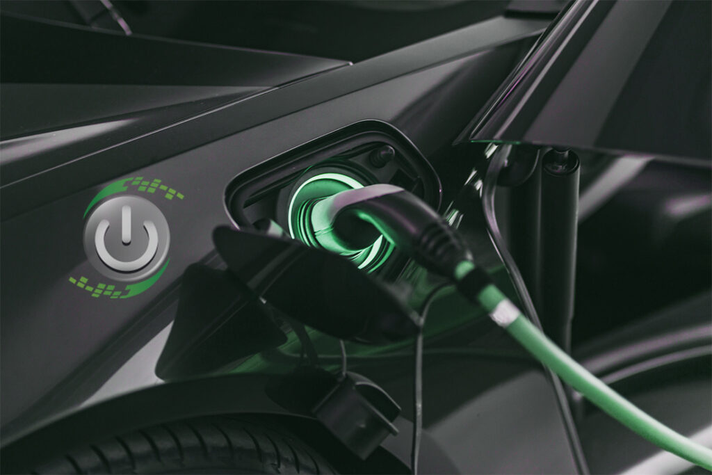 A green glowing electric vehicle charger cable is plugged into a black EV car with the EV Solar logo overlaid